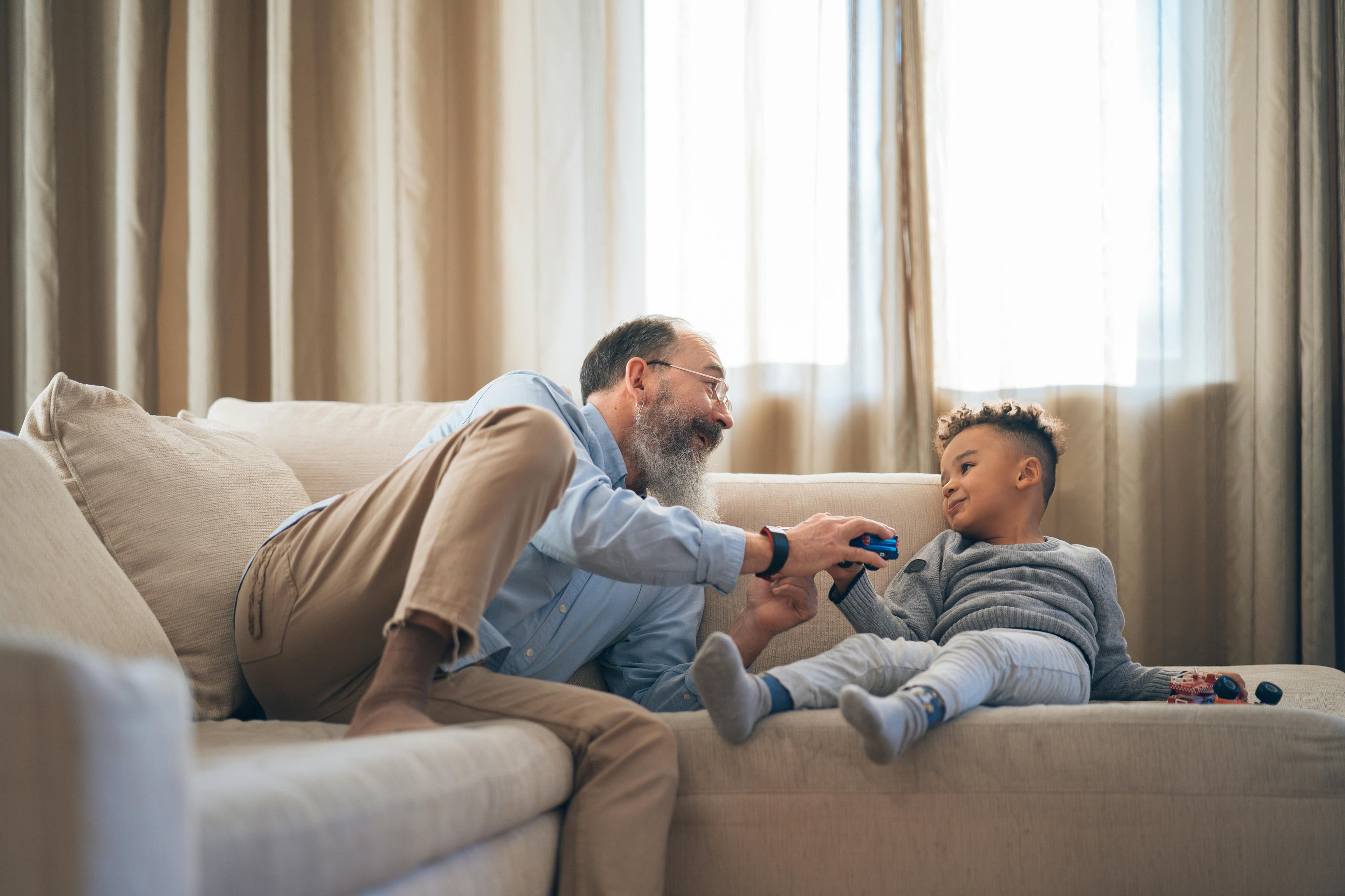 A grandfather and grandson playing together